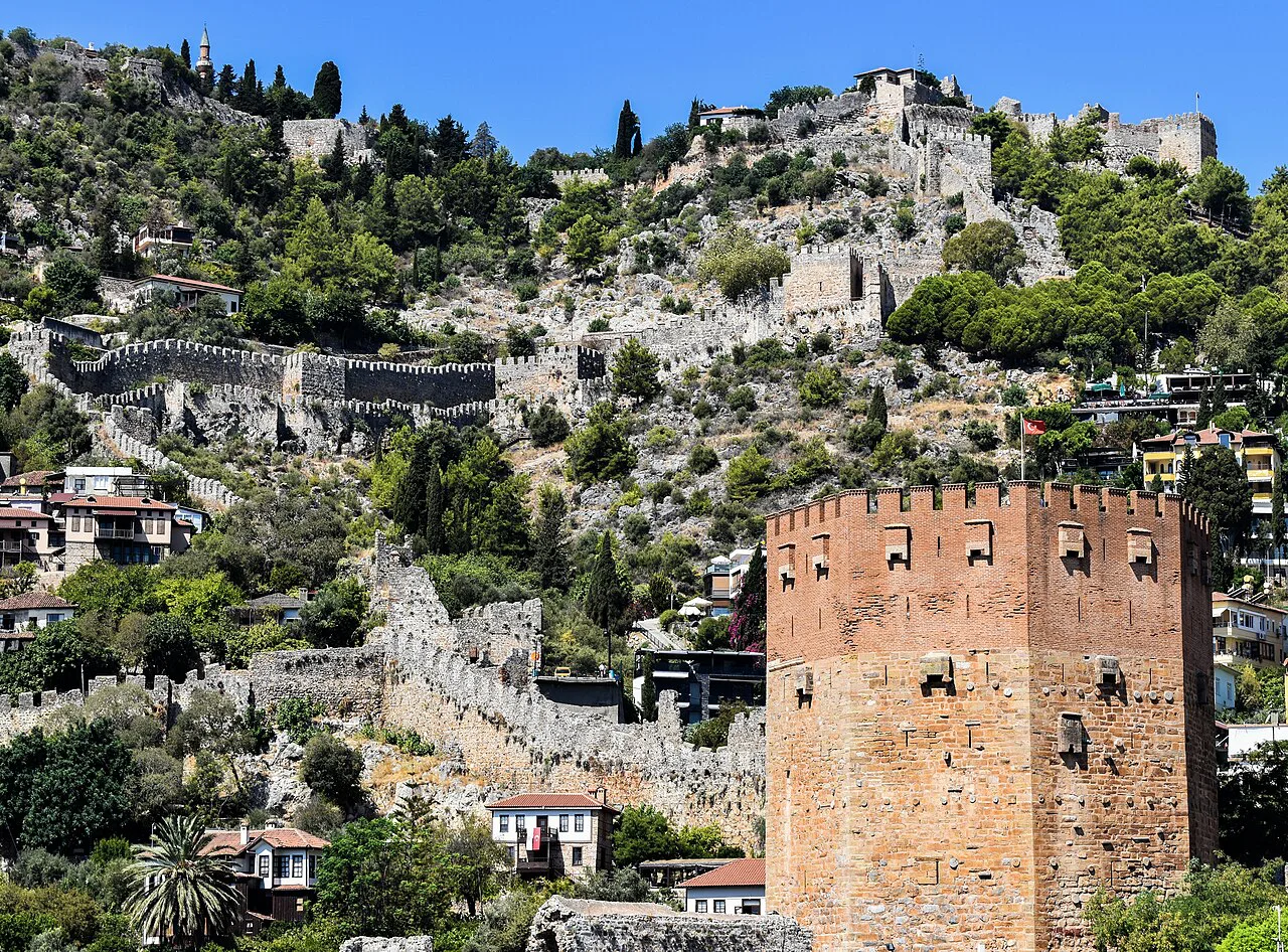 The Red Tower in Alanya with Alanya Castle on the hill behind.