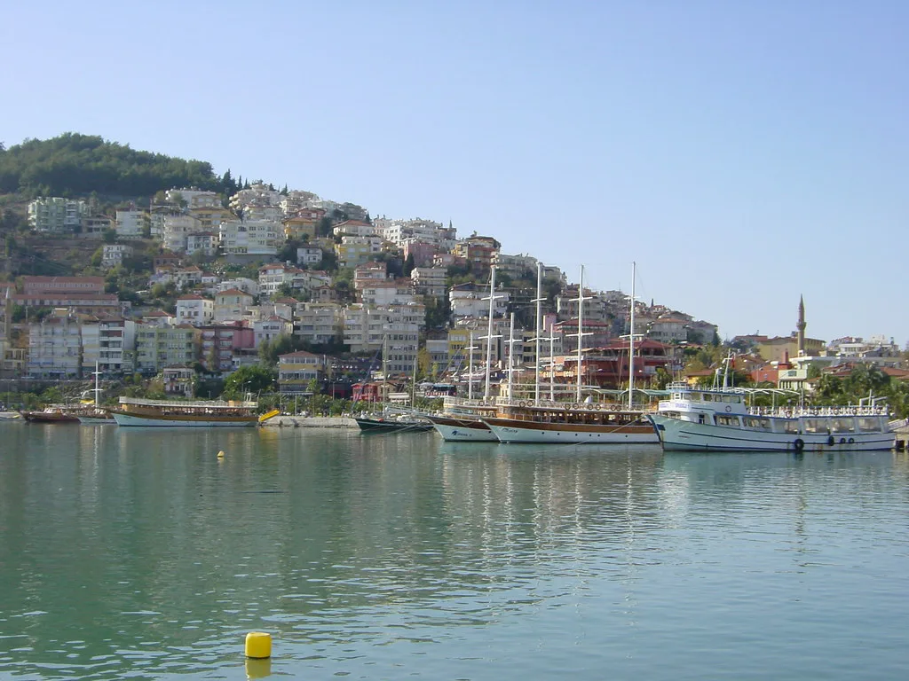 Excursion boats moored in Alanya harbour below the hillside town.
