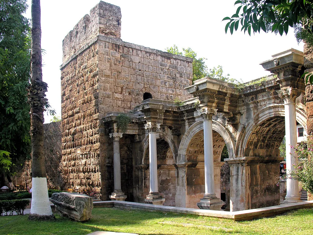 Hadrian's Gate and its flanking stone tower in Antalya's old town.