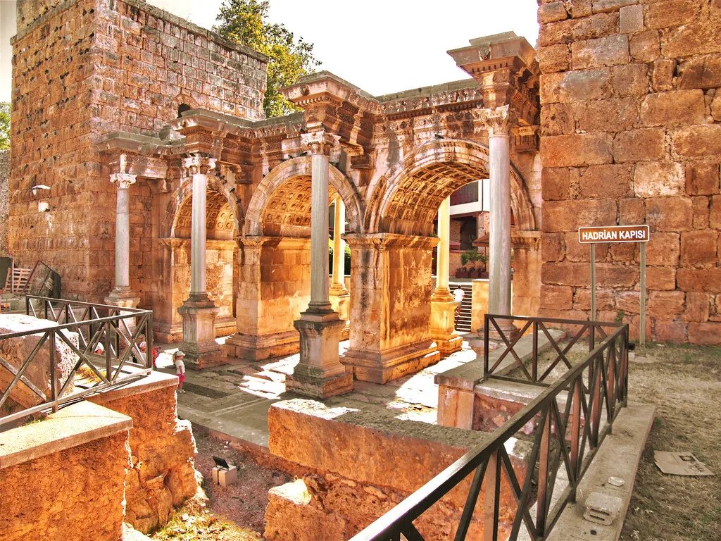 The arches of Hadrian's Gate in Antalya, seen from inside the railings.