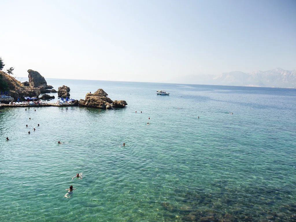 Clear water below the rocky shore at Antalya's old town.