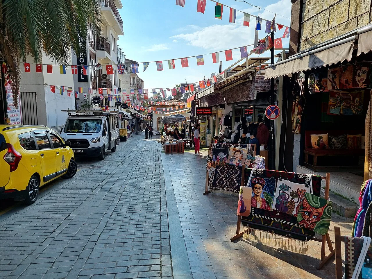 A shop-lined street in Antalya's old town decorated with Turkish flags.