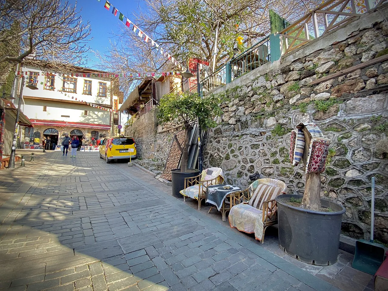 A steep lane with café chairs in Kaleiçi, Antalya's old town.