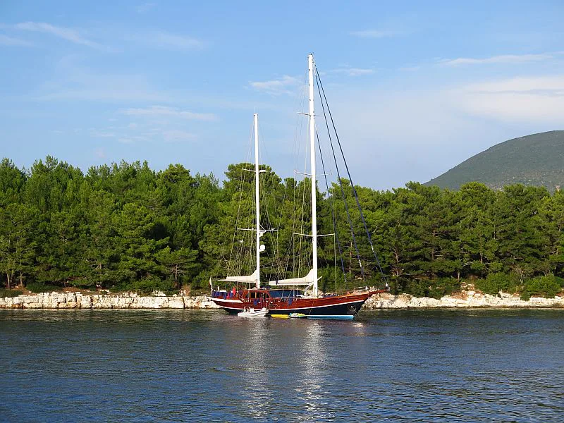 A gulet anchored in a wooded bay in Turkey.
