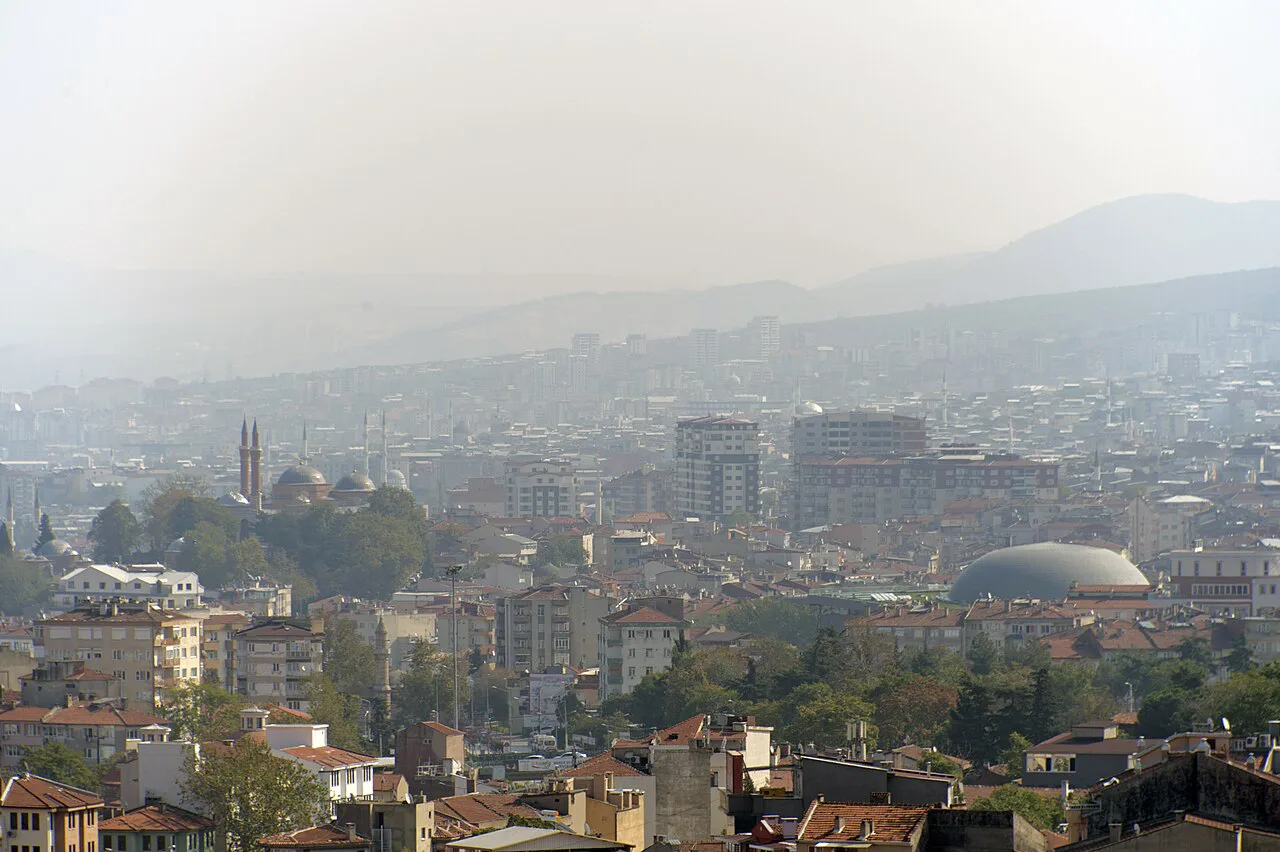 Central Bursa and its mosques seen from a hillside on a hazy day.
