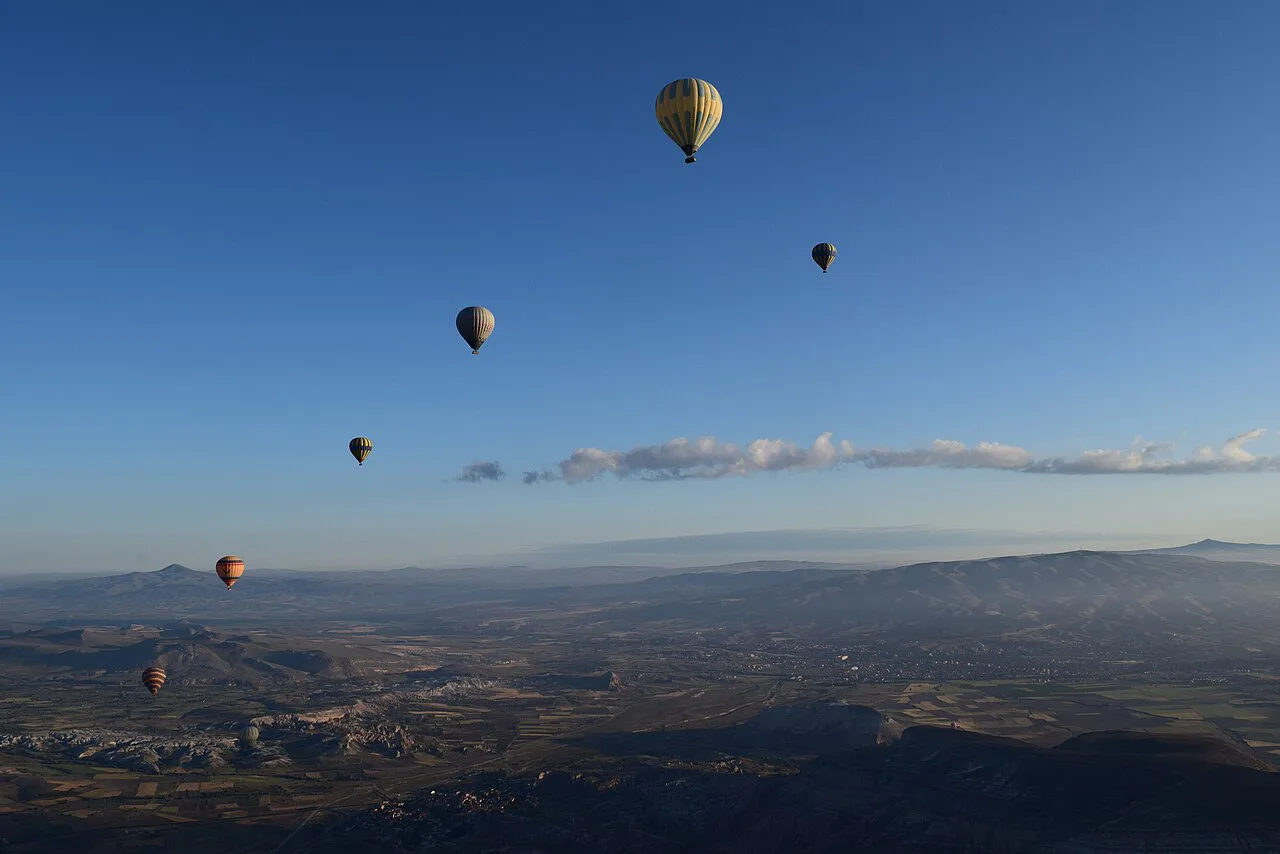 Hot-air balloons in the early-morning sky over Cappadocia.
