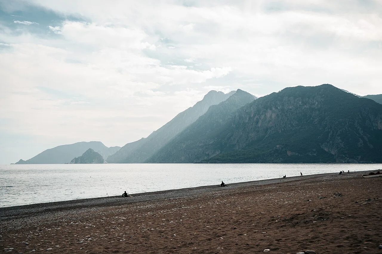 The beach at Olympos with the coastal mountains beyond.