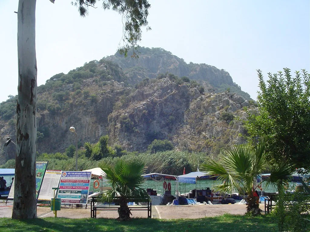 The riverside in Dalyan with rocky hills behind.