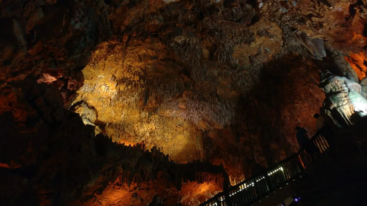 Lit stalactites and dripstone formations inside Damlataş Cave, Alanya.