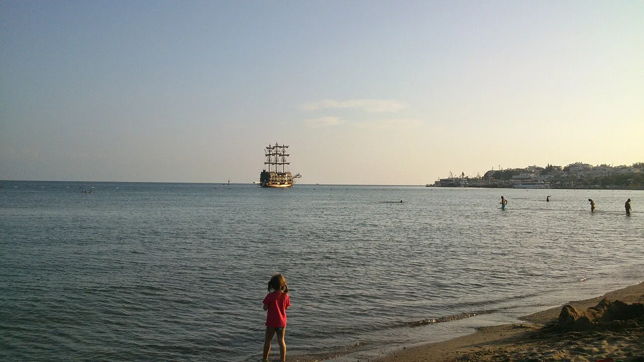 Evening on the shore at Altınkum, Didim, with a gulet offshore.
