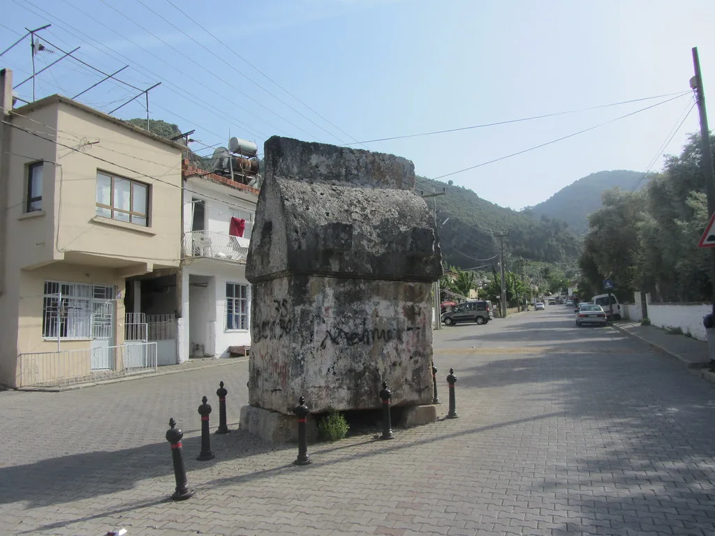 A Lycian sarcophagus standing in a street in Fethiye.