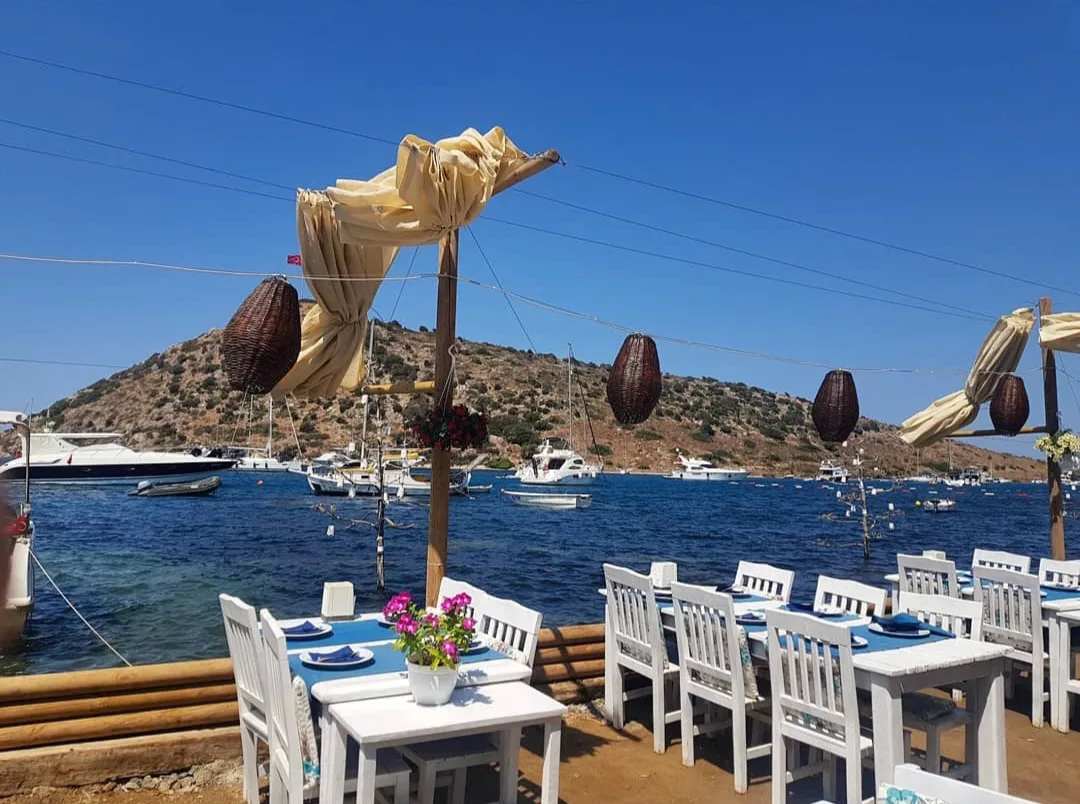 Waterfront restaurant tables beside the bay at Gümüşlük.