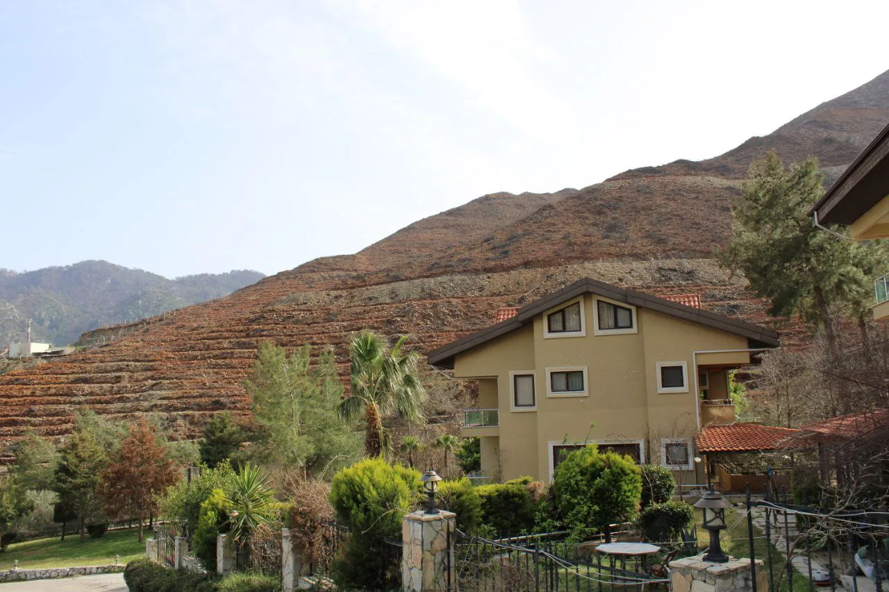 A house below the hills above İçmeler.