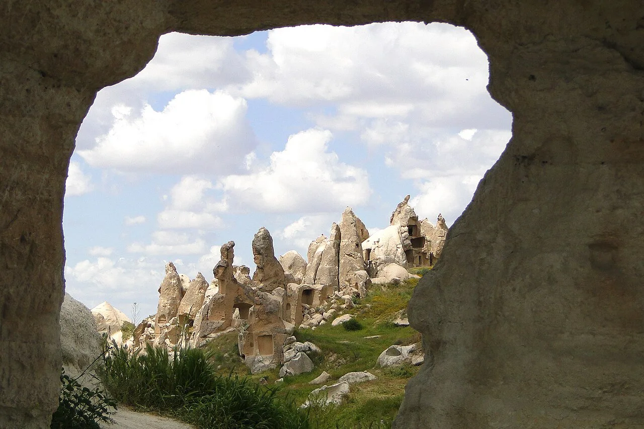 Fairy chimneys framed by a rock opening at the Göreme Open-Air Museum.