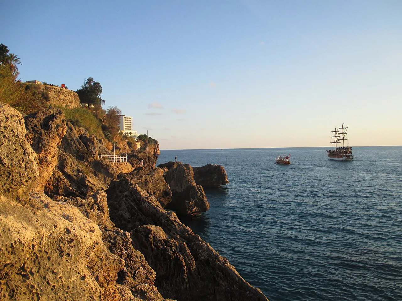 The cliffs below Karaalioğlu Park with a sightseeing boat offshore.