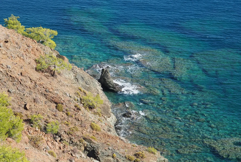 Rocky shoreline and clear water on the Lycian Way between Çıralı and Maden Bay.
