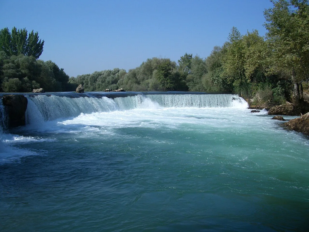 The Manavgat Waterfall spilling across the width of the river.