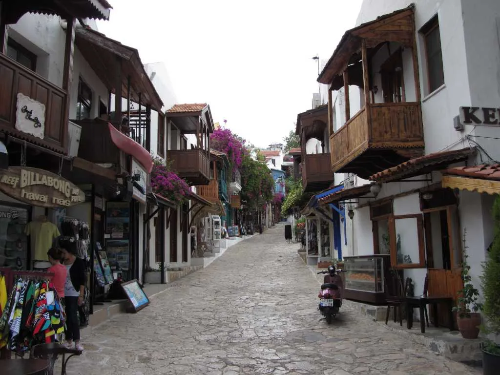 A typical lane in Kaş lined with shops and wooden balconies.