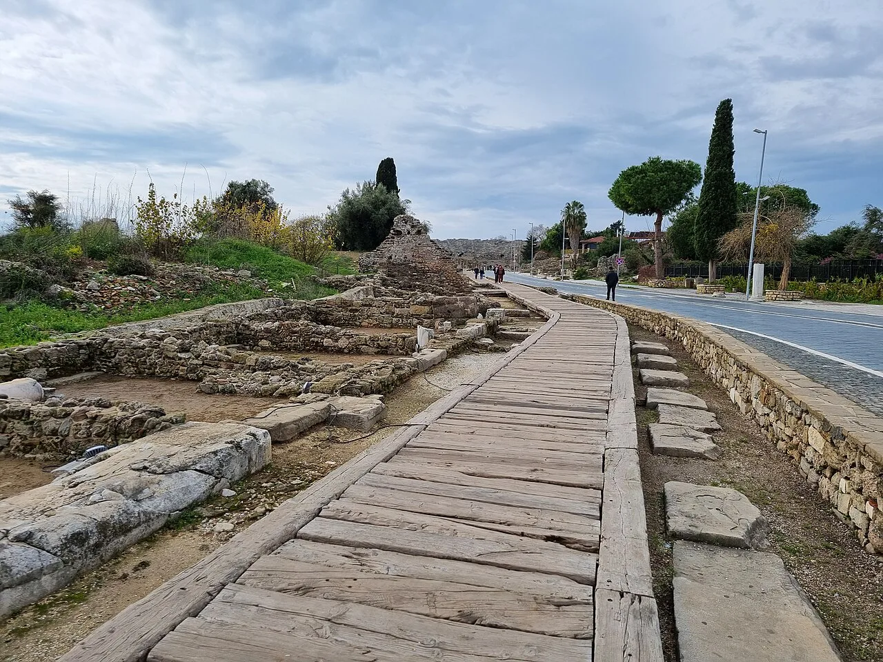 A boardwalk running past ancient ruins along the coast in Side.