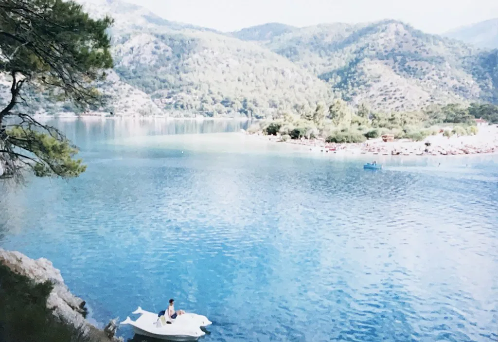 The calm lagoon at Ölüdeniz below forested mountains.