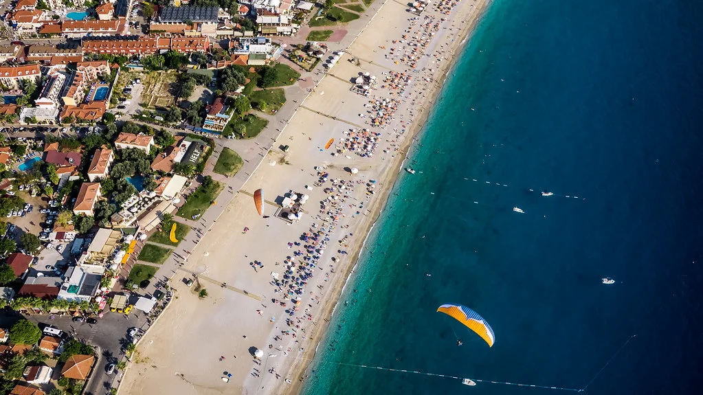 A paraglider over the beach at Ölüdeniz, seen from the air.