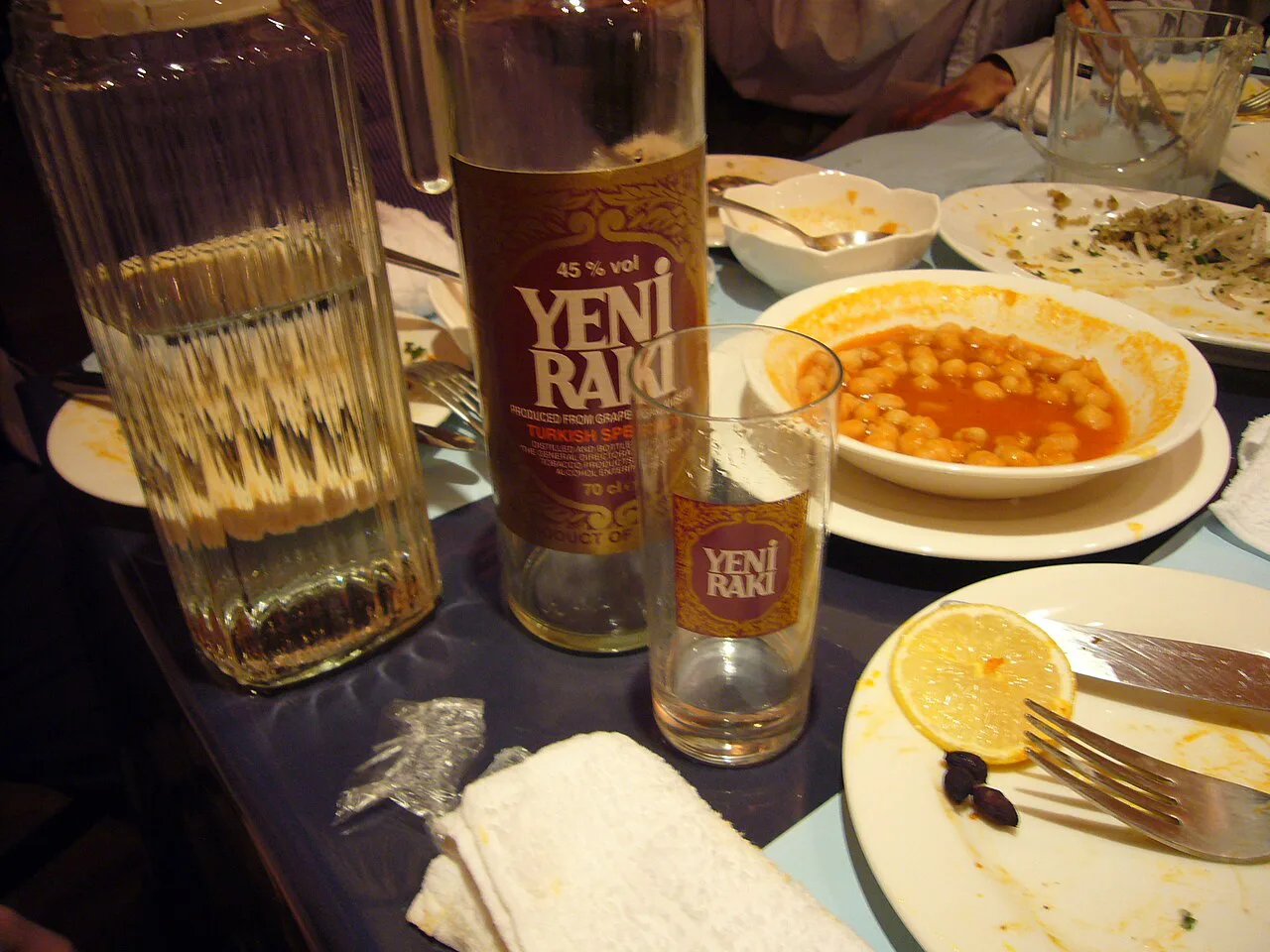 Rakı served with chickpeas and meze plates.