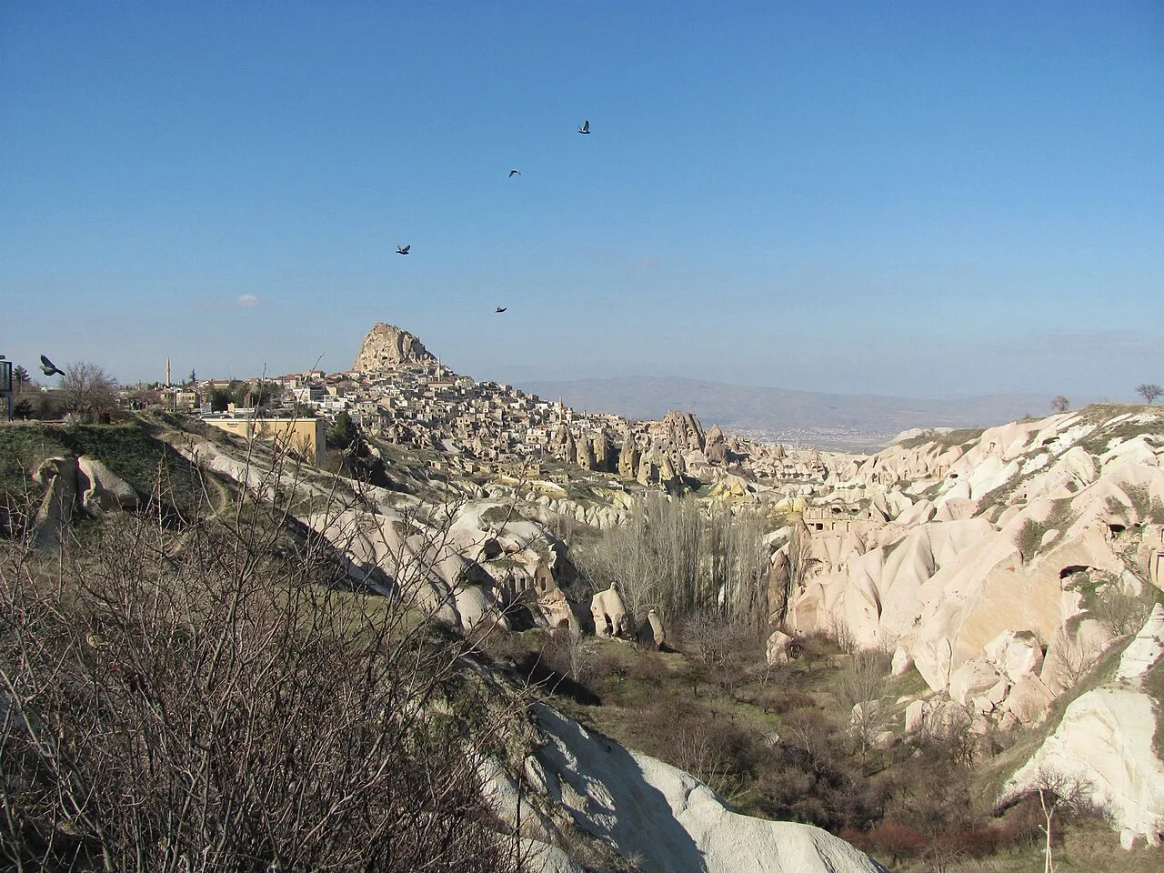 Rose Valley's rock formations with Uçhisar on the horizon.