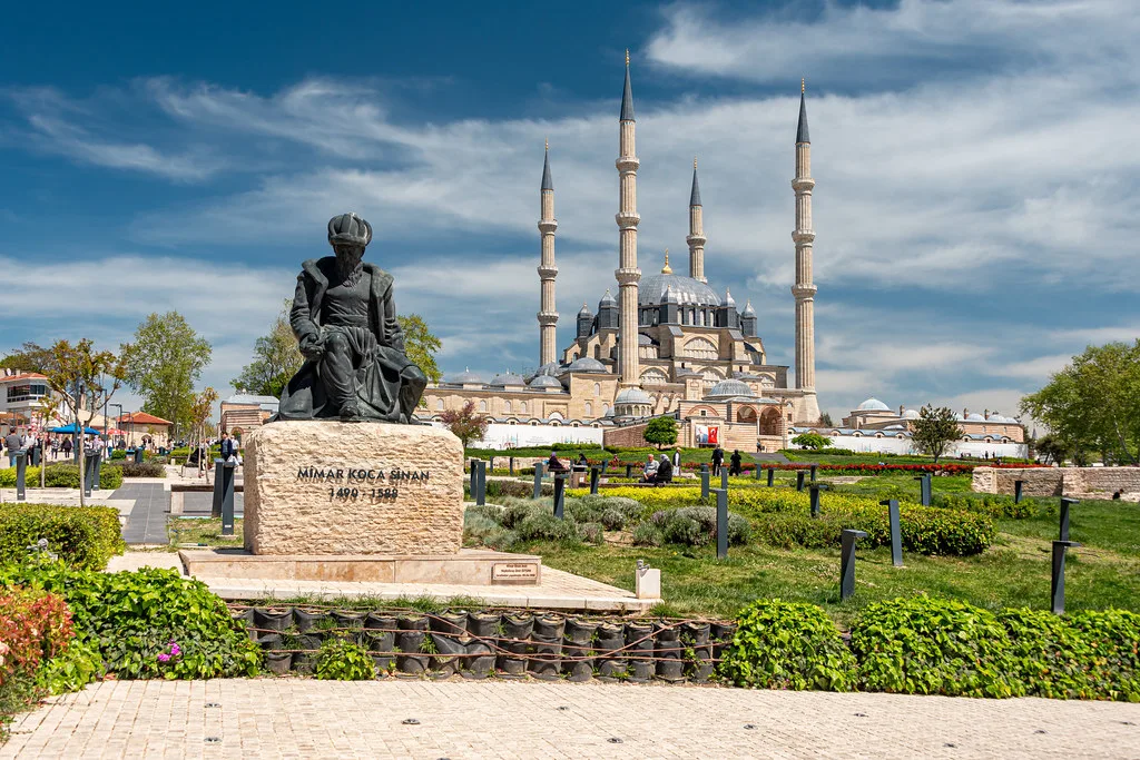 The Selimiye Mosque in Edirne, seen across the gardens beside a statue.