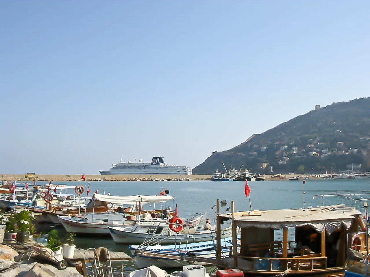 Boats in Alanya harbour with the castle hill behind.