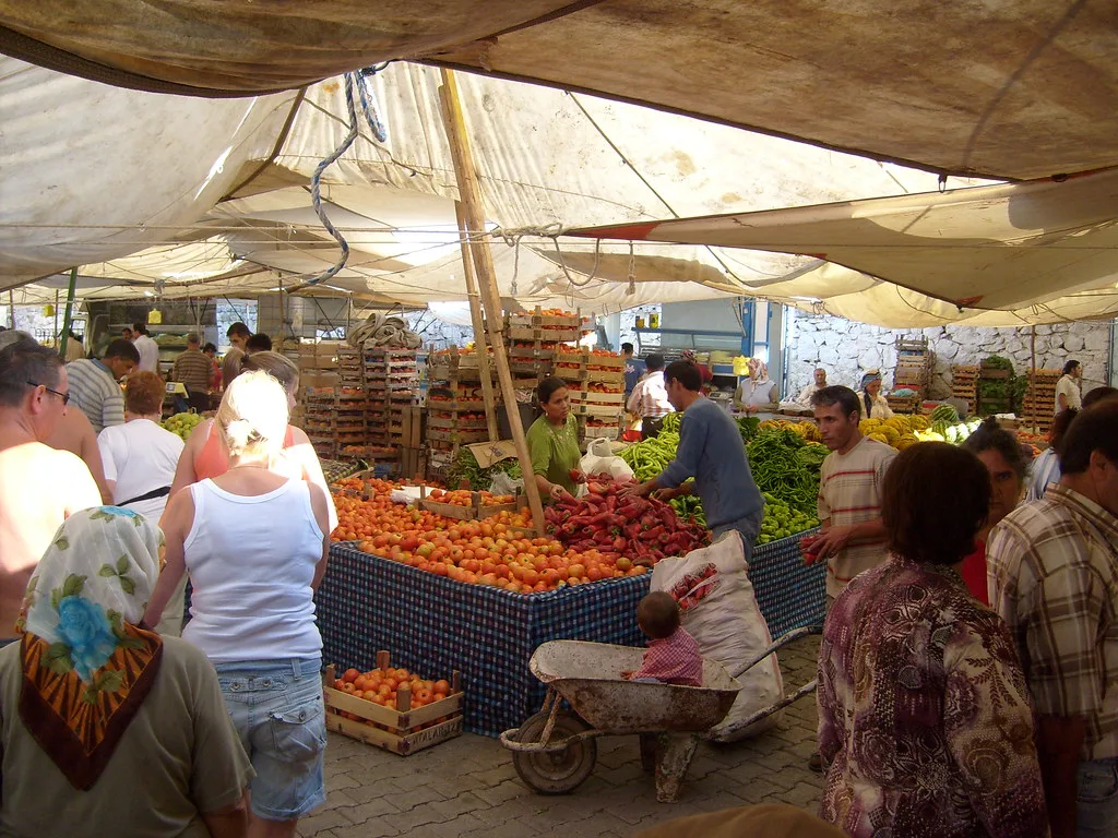 Fruit and vegetable stalls under awnings at the Fethiye market.