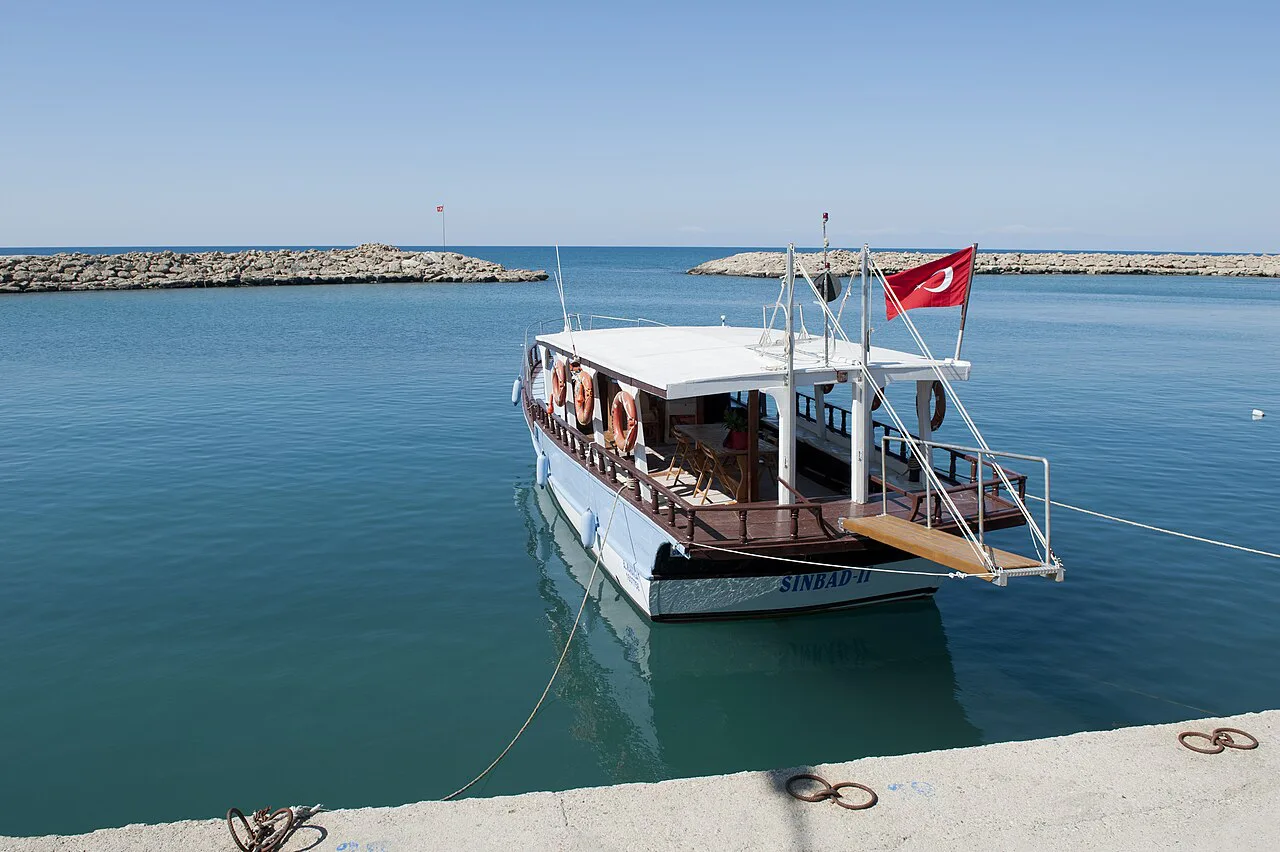 A tour boat flying the Turkish flag in Side harbour.