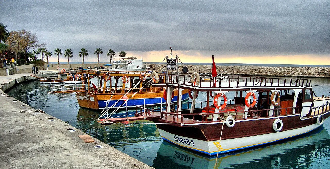 Tour boats moored at a waterfront in the Side and Manavgat area.