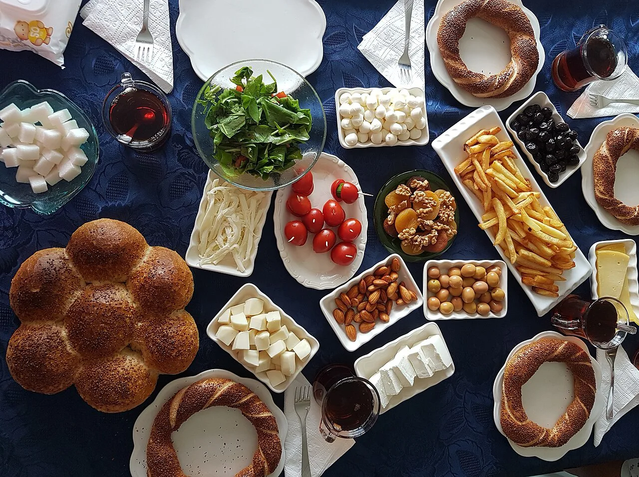 A Turkish breakfast spread with simit, white cheese, olives and tomatoes.