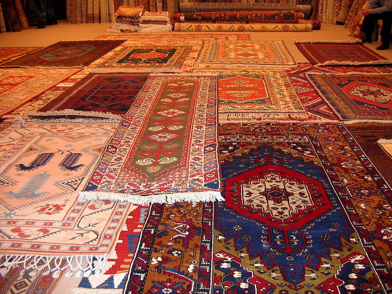 Hand-made Turkish carpets laid out on a shop floor.