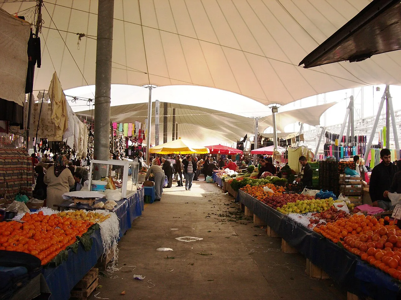 Fruit and vegetable stalls under the canopy of a Turkish pazar.