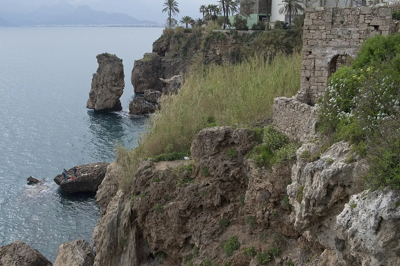 Sea stacks and old walls on the rocky coast near Antalya's old town.